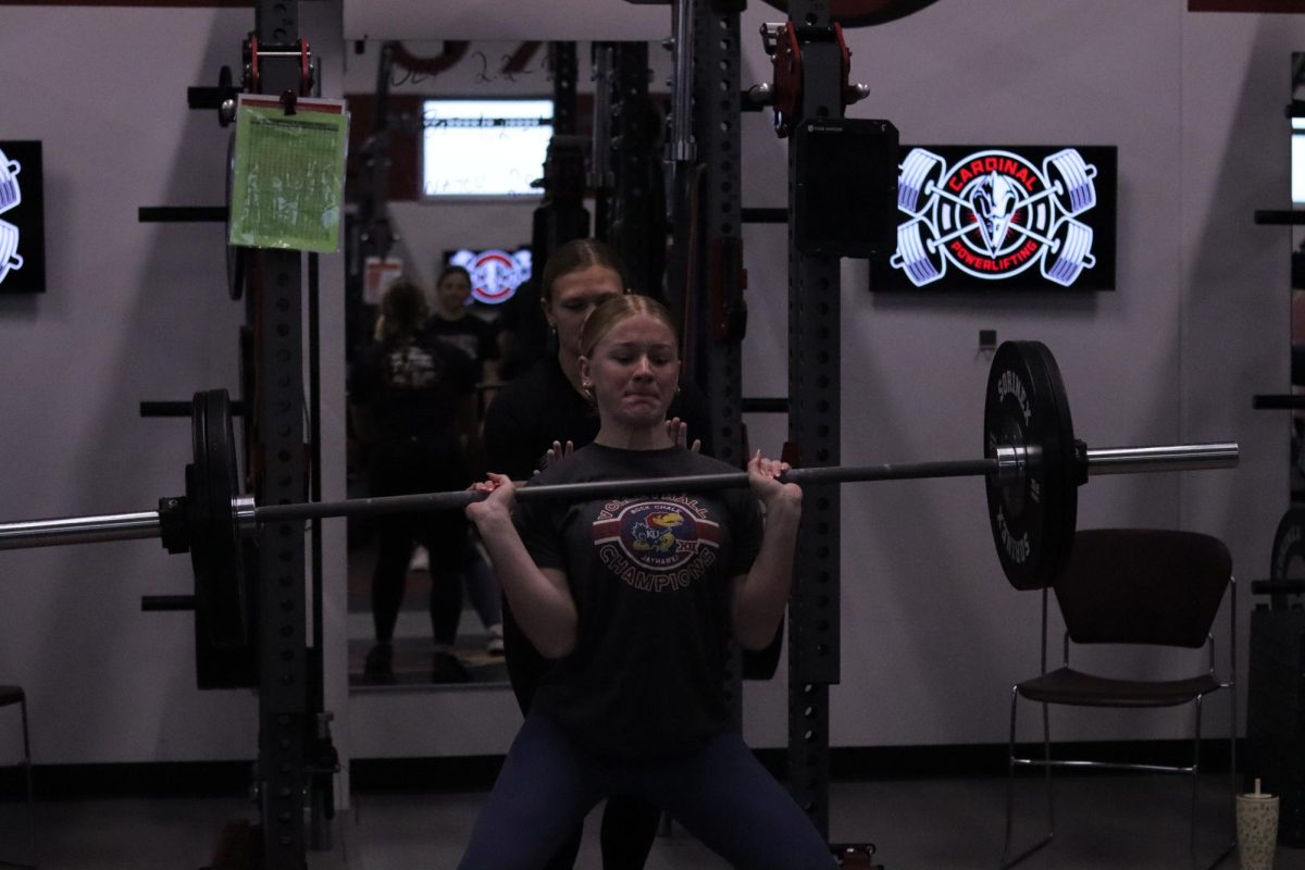 Junior Peyten VanHorn competes in the hand clean lift during a practice competition at EHS Dec. 13.